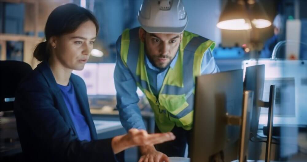 Construction project management consultant coordinating with site engineer on programme and cost oversight